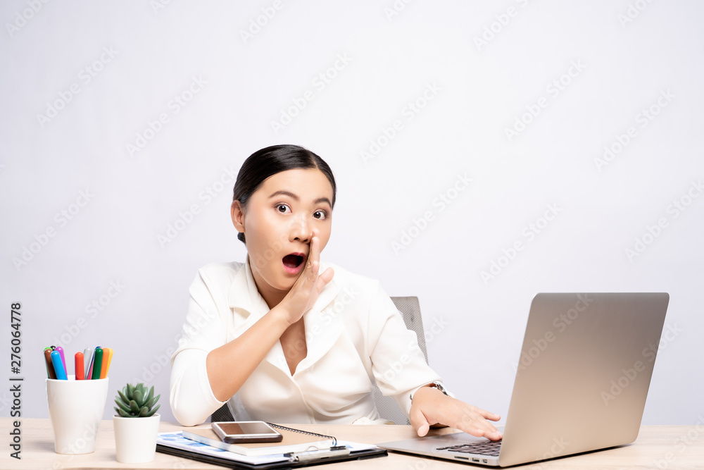 Woman make gossip gesture at office isolated over background Woman make gossip gesture at office isolated over background