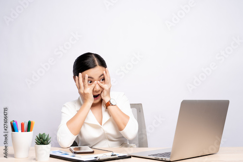 Portrait of a woman feel scared sitting at office isolated over background