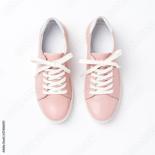 Pink sneakers on white background. Close up