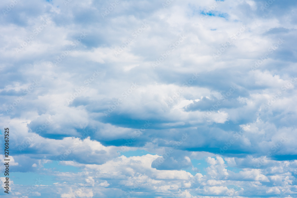 Beautiful white cumulonimbus clouds against the background of the bright blue sky Beautiful white cumulonimbus clouds against the background of the bright blue sky
