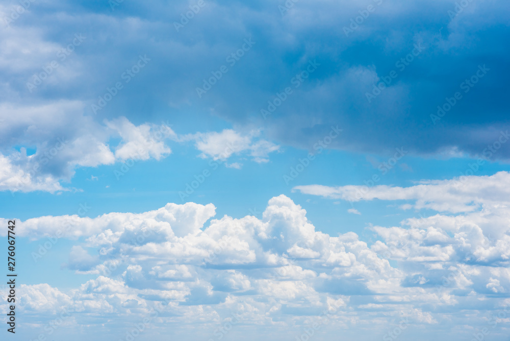 Beautiful white cumulonimbus clouds against the background of the bright blue sky Beautiful white cumulonimbus clouds against the background of the bright blue sky