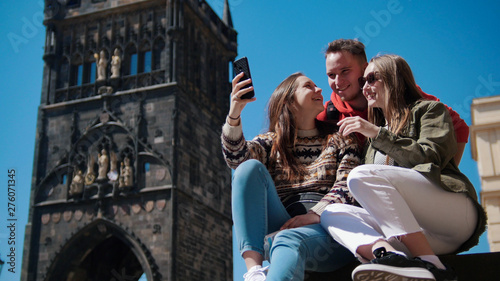 Company of friends laughing and look into the phone. Czech, Prague photo