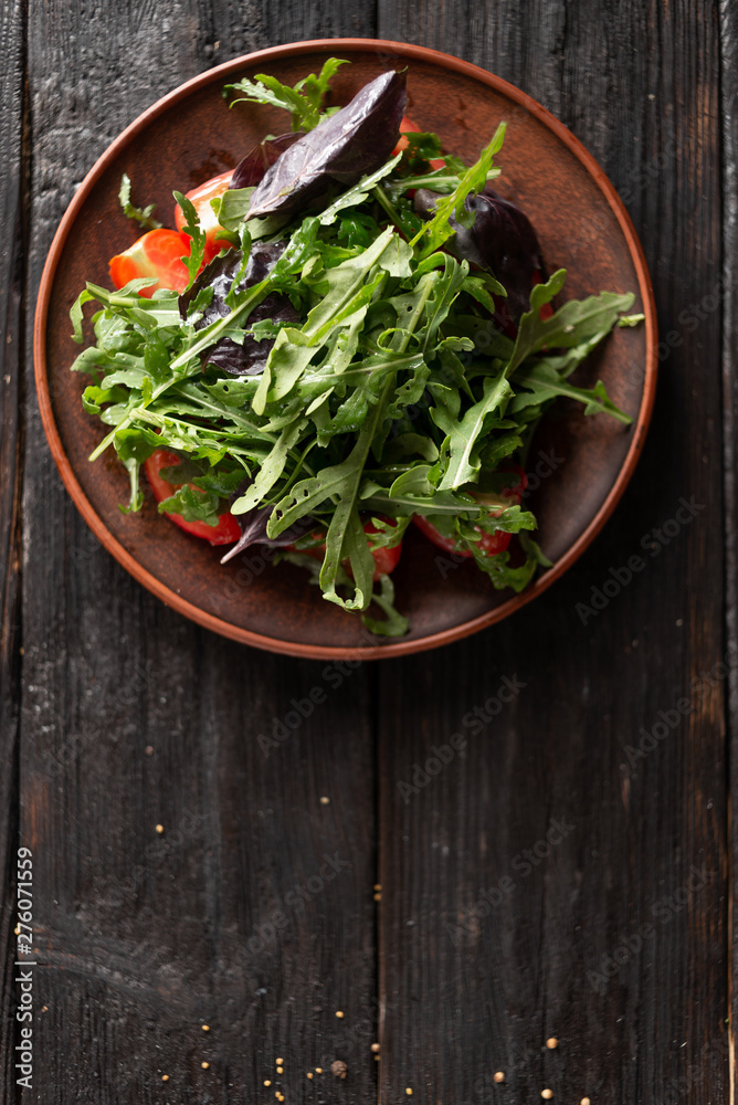 healthy Greek salad with juicy tomatoes feta cheese olives cucumber basil arugula healthy Greek salad with juicy tomatoes feta cheese olives cucumber basil arugula