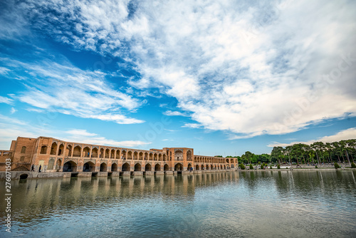 typical view on Khaju Bridge over Zayandeh river ib Isfahan at the daylight with cloudy sky photo