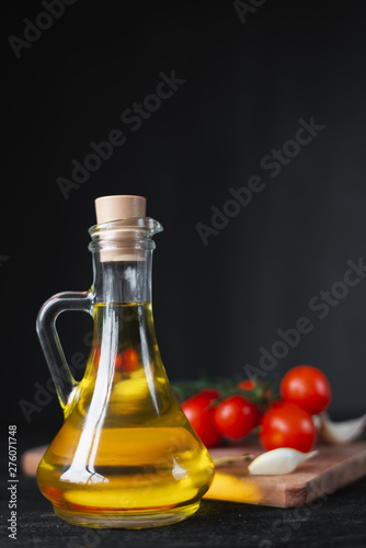 premium bottle of olive oil with cherry tomatoes and spices