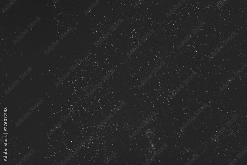 Fototapeta premium White dust and scratches over black surface. Abstract art background. Empty space.