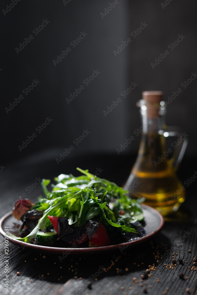 Greek salad with cucumbers, basil, tomatoes, arugula, beautifully laid out on a clay plate Greek salad with cucumbers, basil, tomatoes, arugula, beautifully laid out on a clay plate