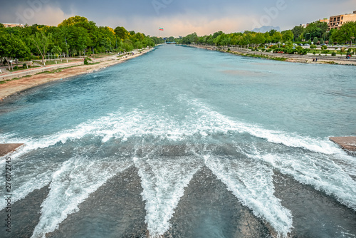 Breakwave on the Zayandeh River with bright blue and maroon water on Khaju Bridge in Isfahan, Iran photo