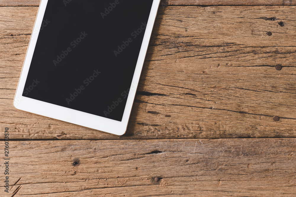 Top view of Pen, notebook, glasses, tablet on wooden table and copy space Top view of Pen, notebook, glasses, tablet on wooden table and copy space