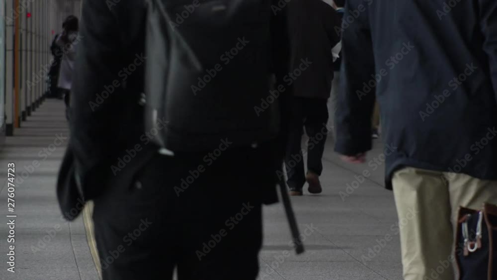 TOKYO, JAPAN - CIRCA APRIL 2019 : Scenery of RUSH HOUR at SHINJUKU. Back shot of unidentified crowd of people going back to home from work at night. TOKYO, JAPAN - CIRCA APRIL 2019 : Scenery of RUSH HOUR at SHINJUKU. Back shot of unidentified crowd of people going back to home from work at night.