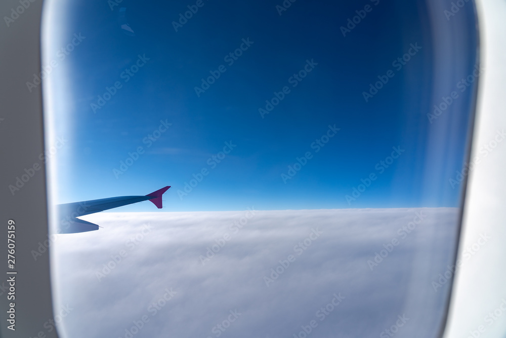 The window of the airplane. A view of porthole window on board an airbus for your travel concept or passenger air transportation The window of the airplane. A view of porthole window on board an airbus for your travel concept or passenger air transportation