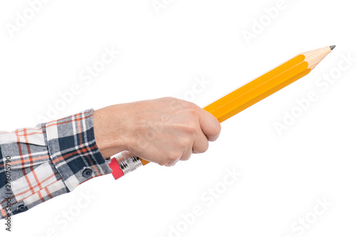 Man hand is holding big pencil and writing on copy space. Isolated on white background. Back to school and education concept.