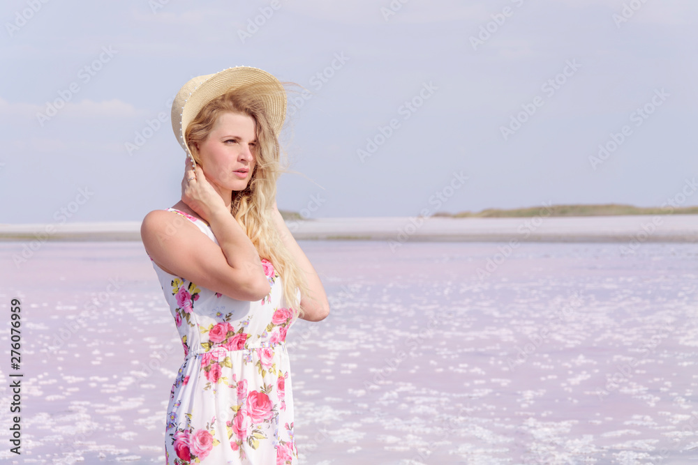 Beautiful young girl in a hat on a background of pink lake. Beautiful young girl in a hat on a background of pink lake.