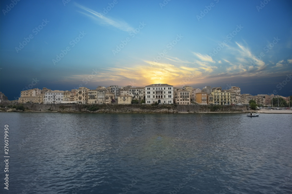 Amazing view from the sea of the Corfu Town old city under the sunset light