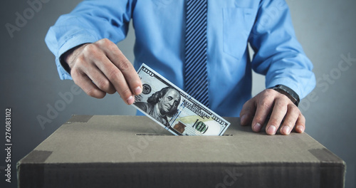 Wallpaper Mural Man putting money on cardboard box. Save money Torontodigital.ca