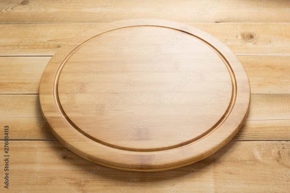 pizza cutting board at rustic wooden table in front pizza cutting board at rustic wooden table in front