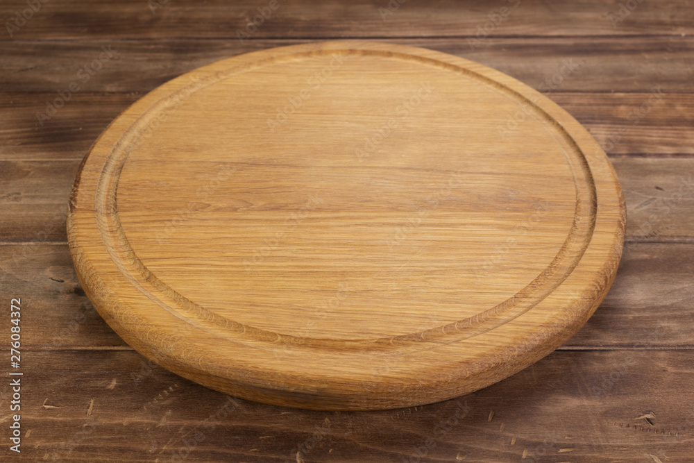 pizza cutting board at rustic wooden table in front pizza cutting board at rustic wooden table in front