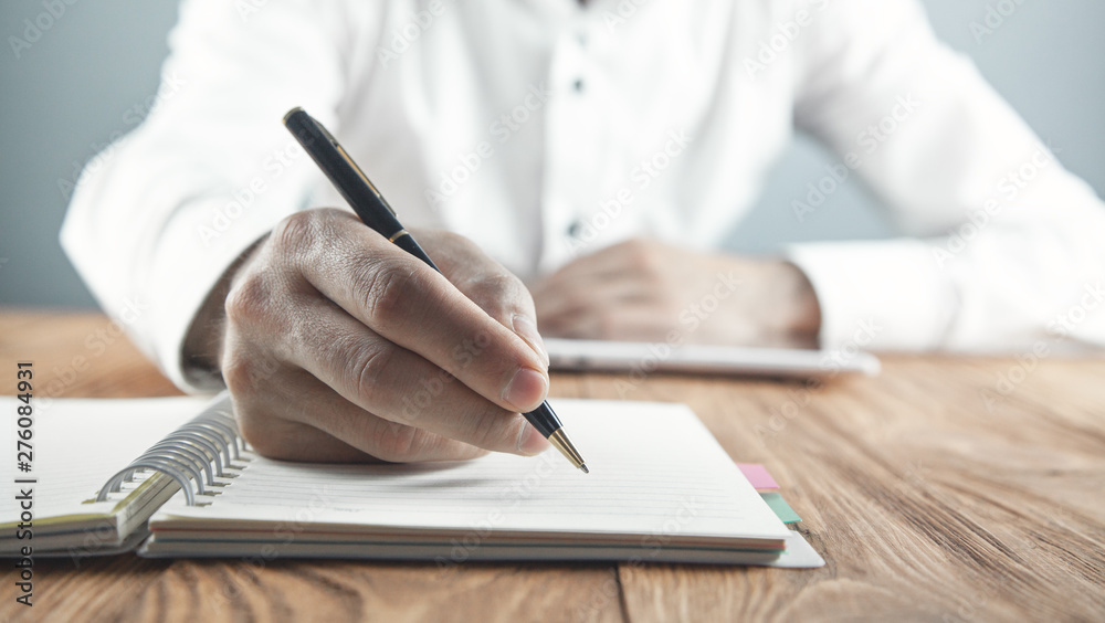 © andranik123 - Businessman writing on a notepad in business desk. © andranik123 - Businessman writing on a notepad in business desk.