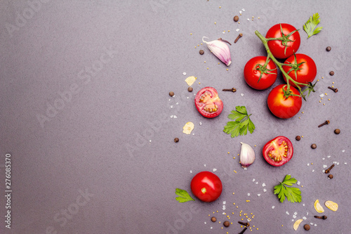 Cooking stone concrete background with spices, herbs, tomatoes