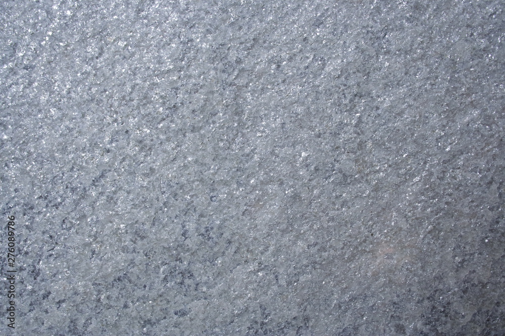 A surface of a architectural stone.(gray, white, purple and sparkling, rough) A surface of a architectural stone.(gray, white, purple and sparkling, rough)