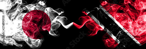 Japan vs Trinidad and Tobago smoky mystic flags placed side by side. Thick colored silky smokes combination of Trinidad and Tobago and Japanese flag