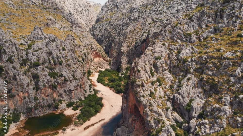 Aerial wide angle view of drone flying into a narrow remote valley near Serra de Tramuntana Road in Mallorca, Spain. Aerial wide angle view of drone flying into a narrow remote valley near Serra de Tramuntana Road in Mallorca, Spain.
