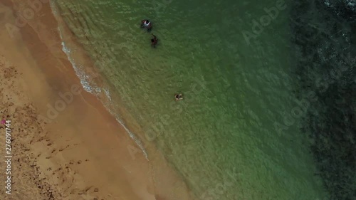 A revealing drone shot of a countyside coastline with waves crashing against the shoreline on the caribbean island of Grenada also known as the spice island photo