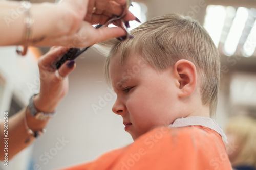 A little boy s haircut in a hairdresser s.
