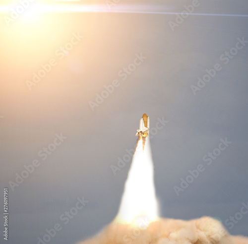 Sunflare and rocket. The elements of this image furnished by NASA. photo