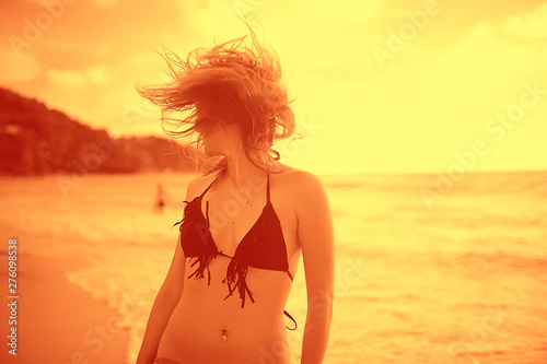 girl is having fun and jumping on beach freedom / concept freedom and summer beach, sporty graceful girl is jumping and having fun beach