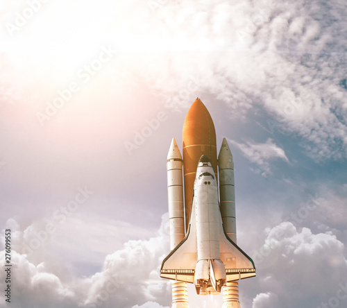 Spaceship Leaving Earth. Space craft taking off into deep space. Elements of this image furnished by NASA. photo