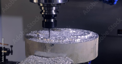 Cnc milling machine. Processing and cutting of parts from a piece of metal in the industrial area. Industrial exhibition of machine tools.