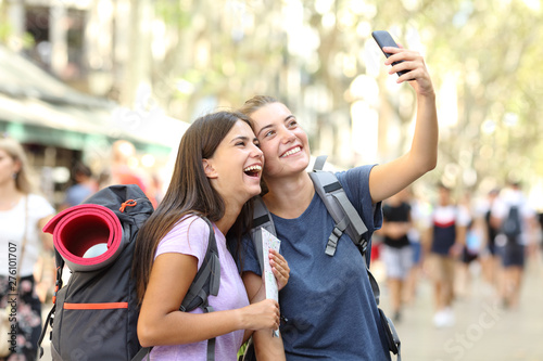Photography Two happy backpackers taking selfies in the street on vacation