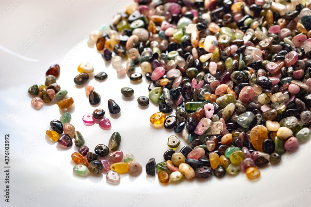 Tourmaline stone beads on white background. Tourmaline stone beads on white background.