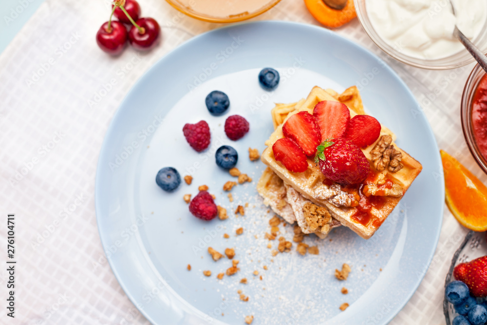 Plate with delicious waffles with fresh strawberry Plate with delicious waffles with fresh strawberry