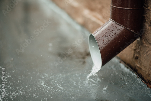 Rainwater flows out of the drainpipe
