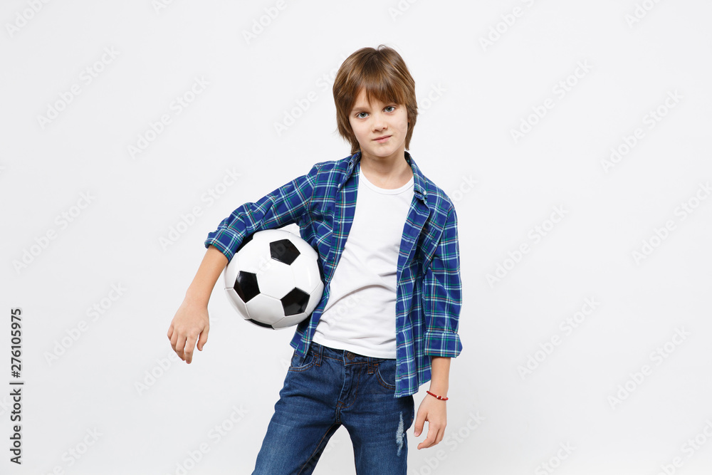 Football fan kid boy blue t-shirt cheer up support favorite team with soccer ball isolated on white wall background children studio portrait. People childhood sport family leisure lifestyle concept.