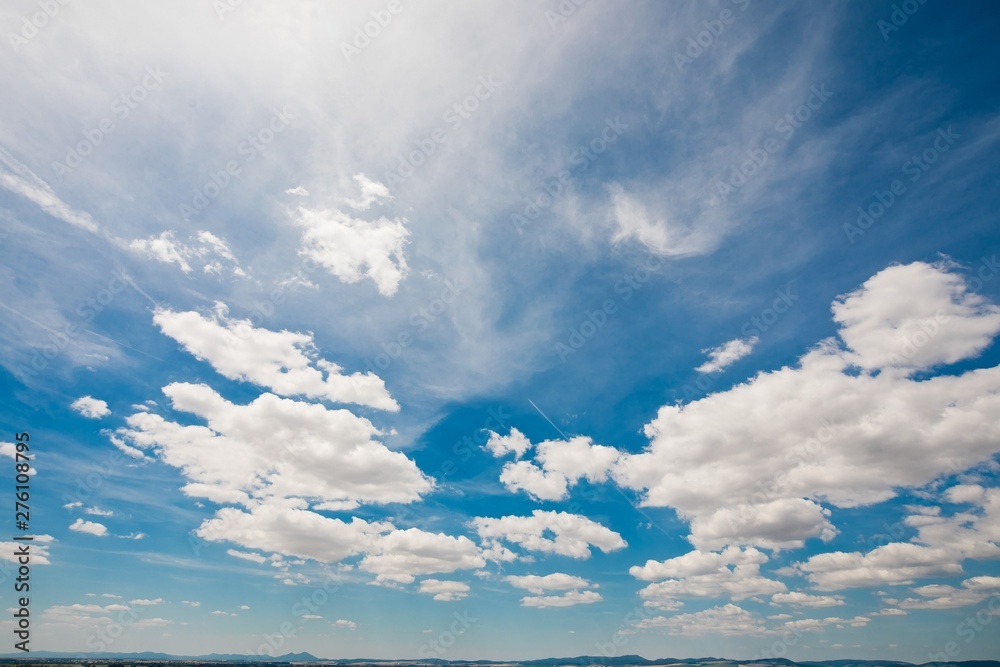 Clouds on sky with low horizon, wide shot or blue sky during sun Clouds on sky with low horizon, wide shot or blue sky during sun