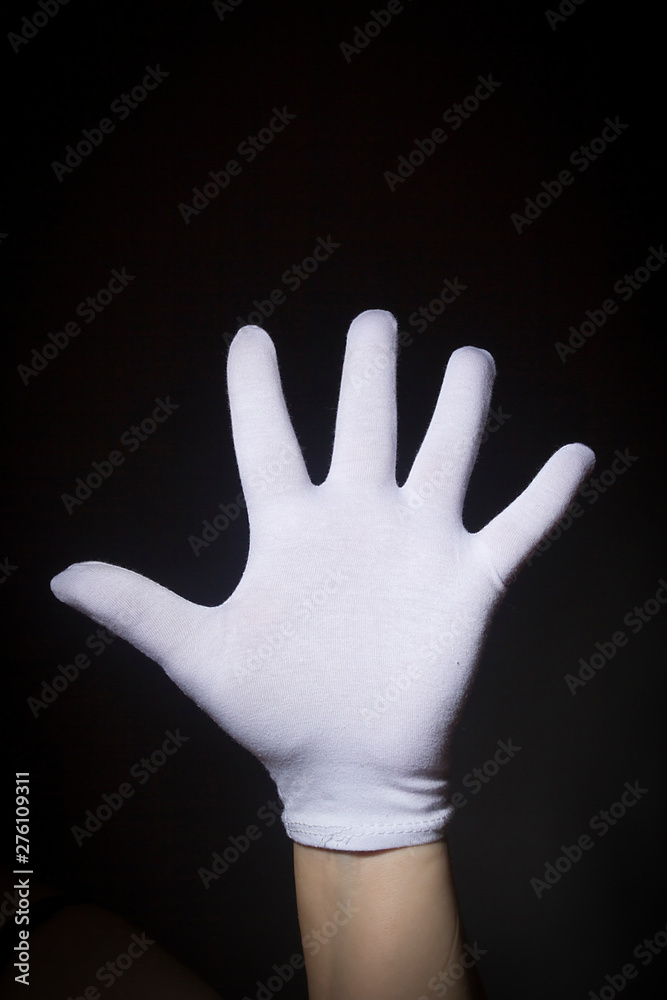 White gloved hand showing number five White gloved hand showing number five