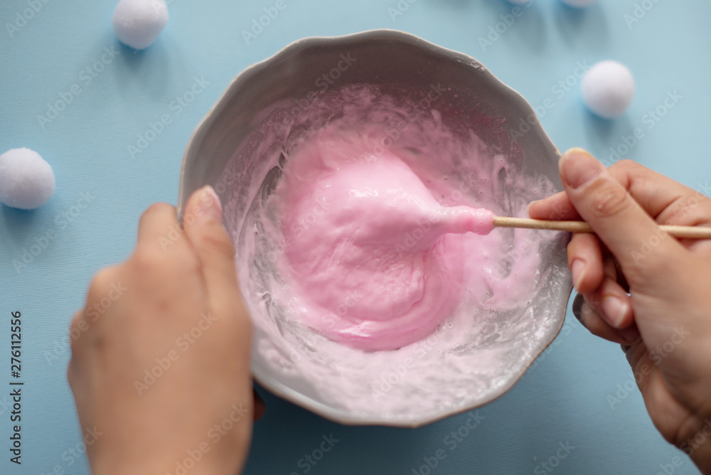 Fototapeta premium a girl making slime herself. child making slime. 