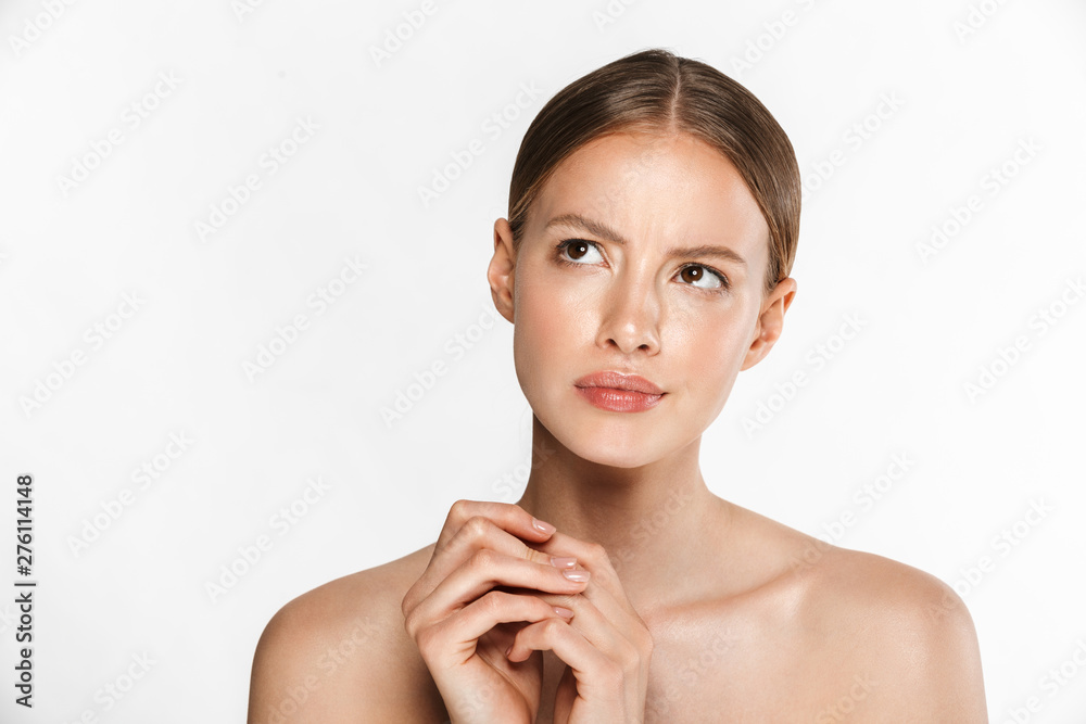 Beautiful displeased confused young woman posing isolated over white background wall. Beautiful displeased confused young woman posing isolated over white background wall.