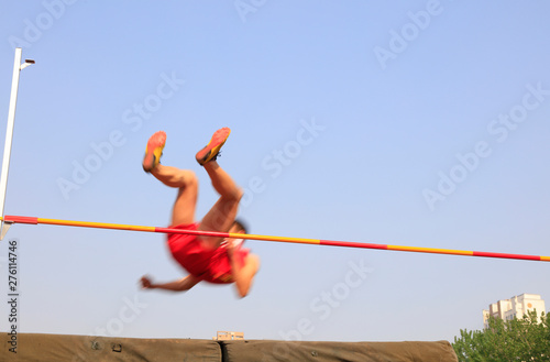 men high jump athletes in the playground