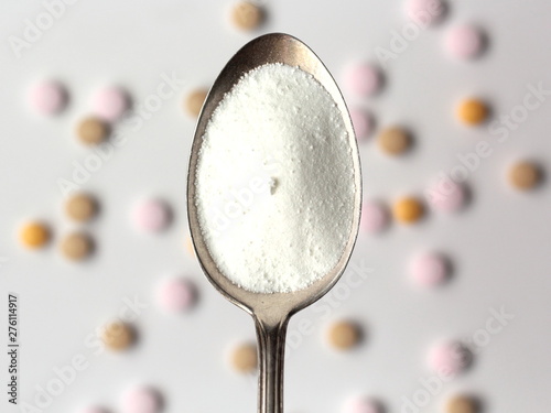 Closeup of myo-inositol powder on a spoon. Myo-inositol is a commonly used supplement for treating PCOS symptoms. photo