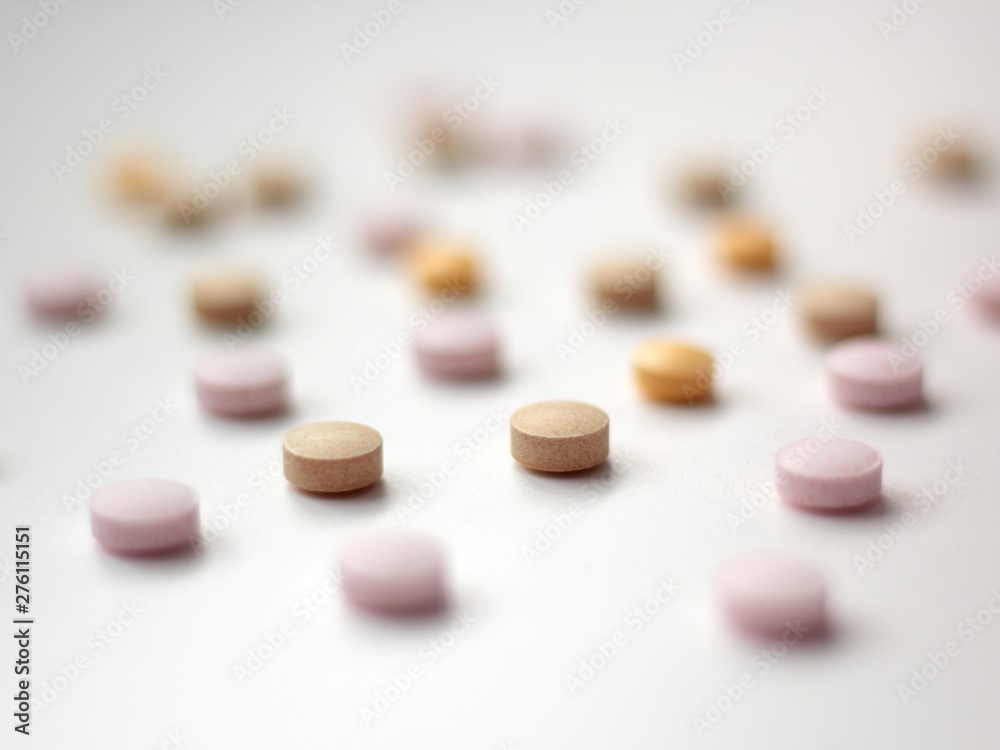Closeup of colourful pills on white background. Closeup of colourful pills on white background.