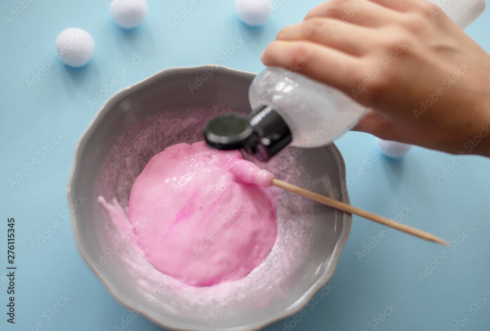 a girl making slime herself. child making slime. a girl making slime herself. child making slime.