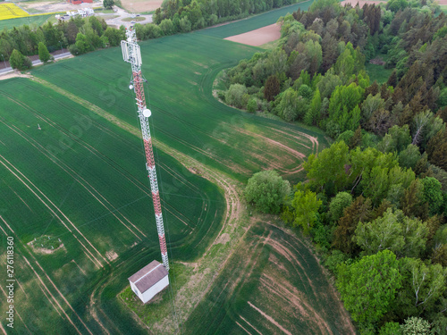 Aerial shot of mobile tower in green fields