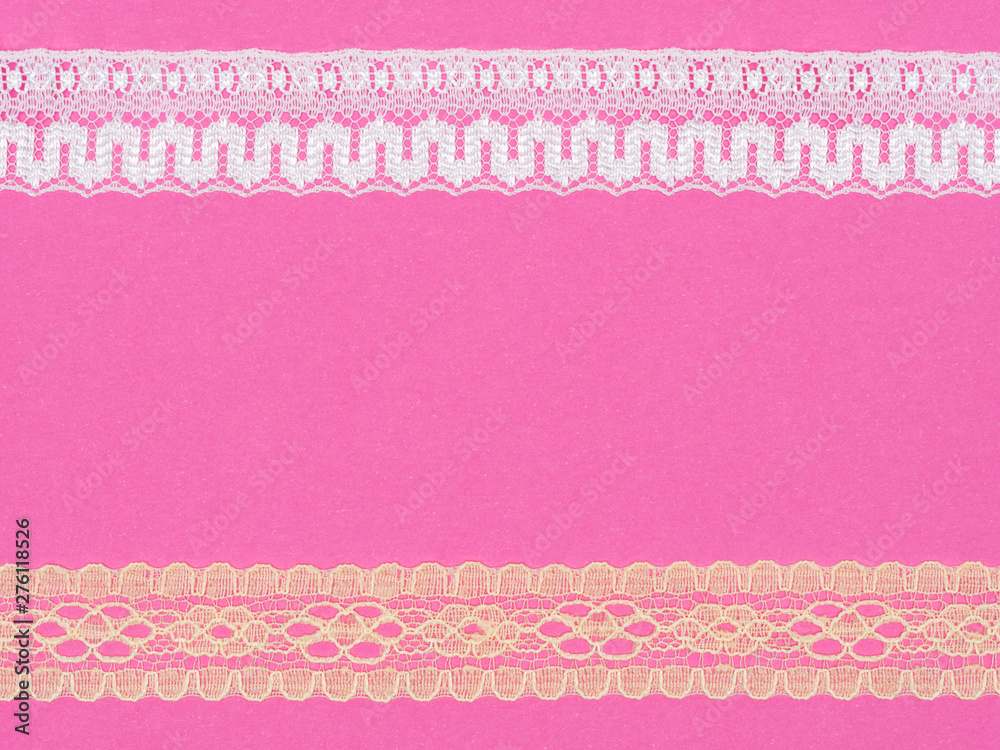 White and beige lace on pink background