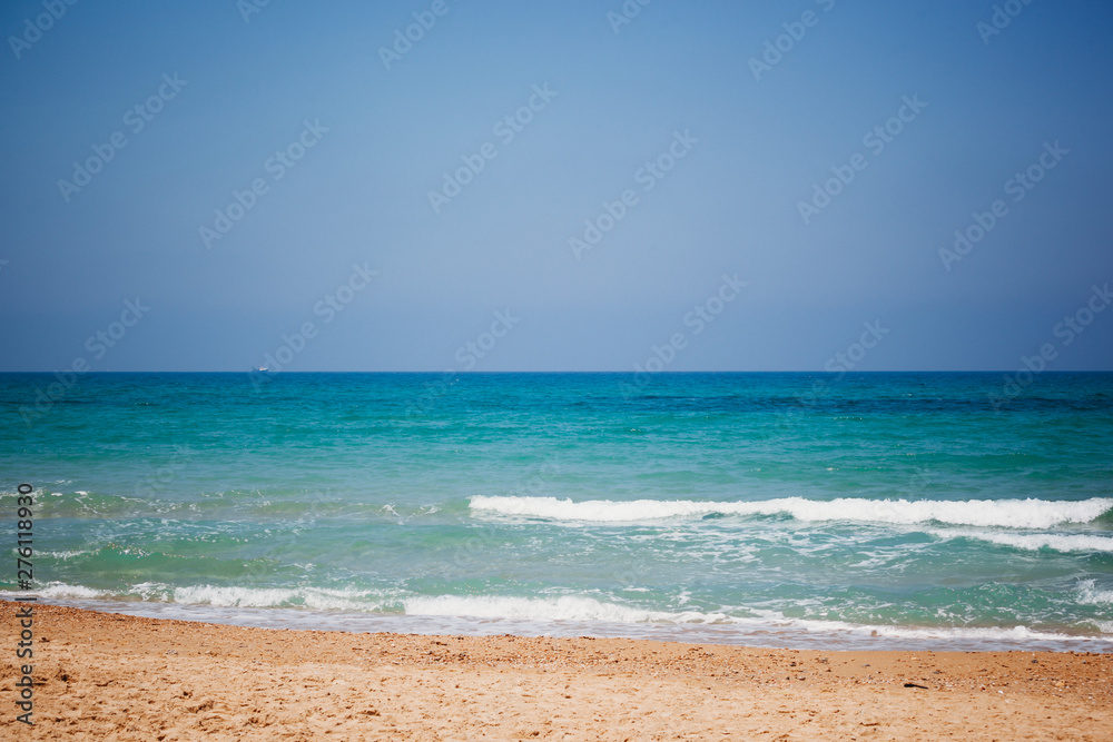 Mediterranean beach with turquoise water in sunny weather