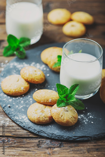 Homemeade cookies with milk on the wooden table photo