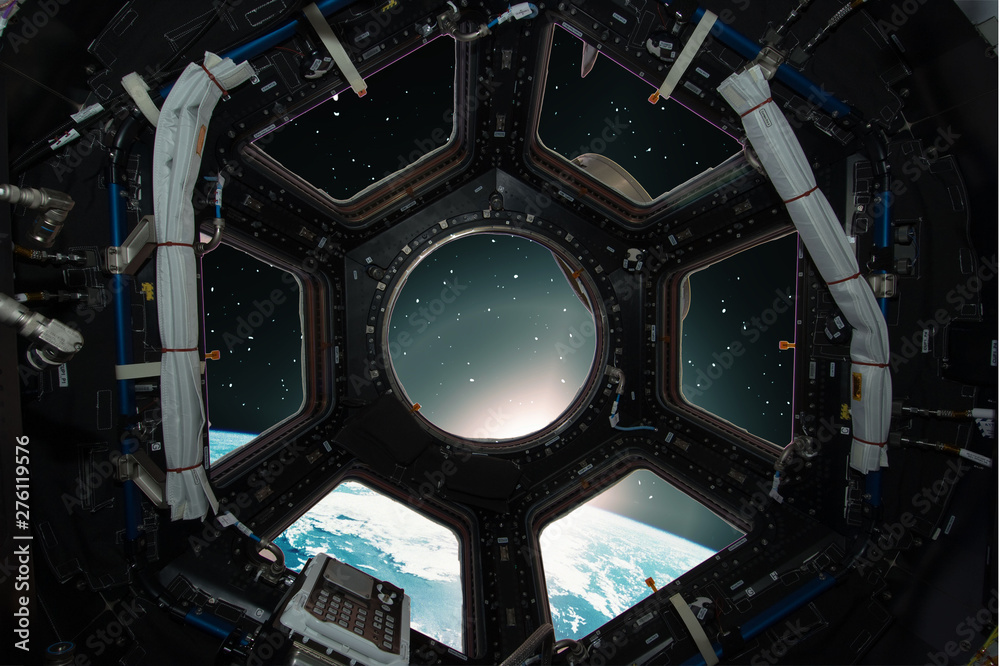 Fototapeta premium Fascinating sunrise on earth. Spaceship window view. Elements of this image furnished by NASA.